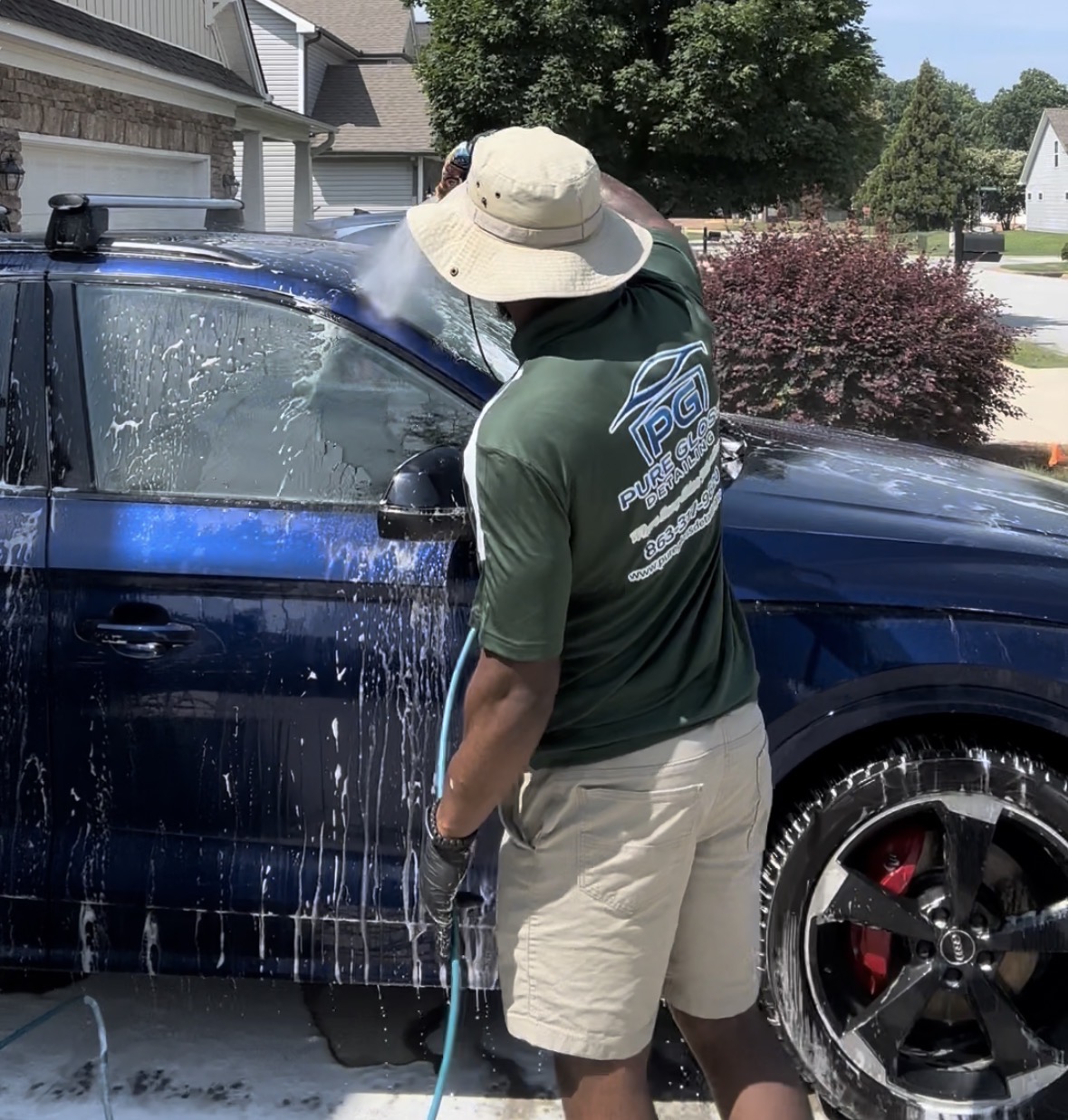 Mobile car detailing in Spartanburg SC — Pure Gloss Detailing hand-washing a vehicle on-site